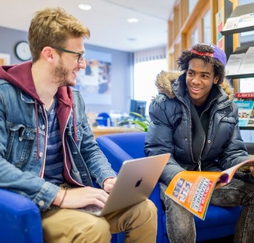 2 male students in library