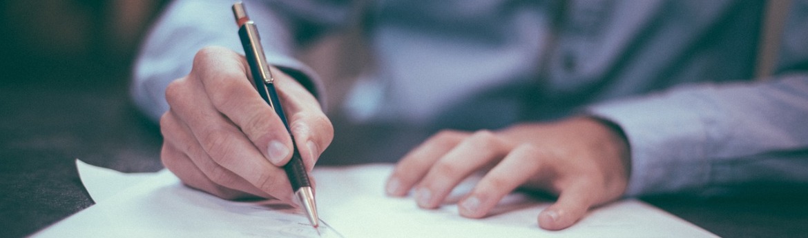 person writing at desk