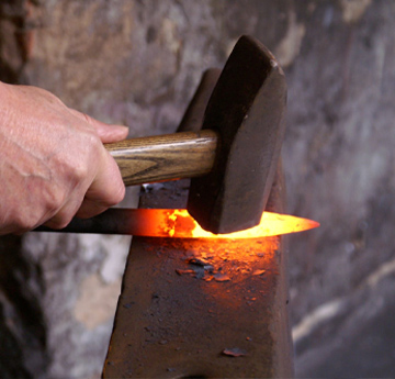 A man hammering hot metal