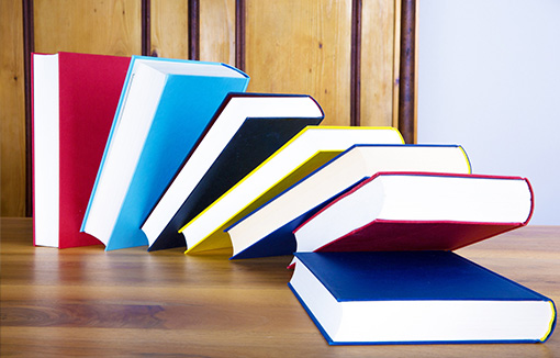 a pile of bookmarked textbooks