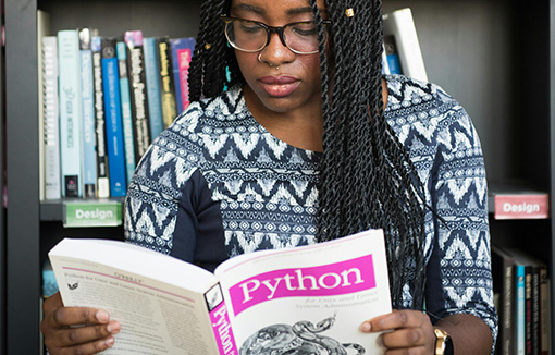 a student looking at a Python textbook