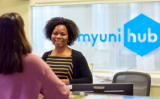 Student talking to woman at MyUni Hub