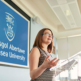 A female lecturer standing at podium