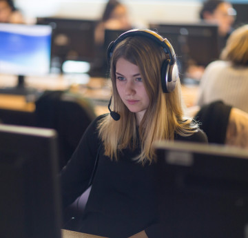 Student on computer wearing headset