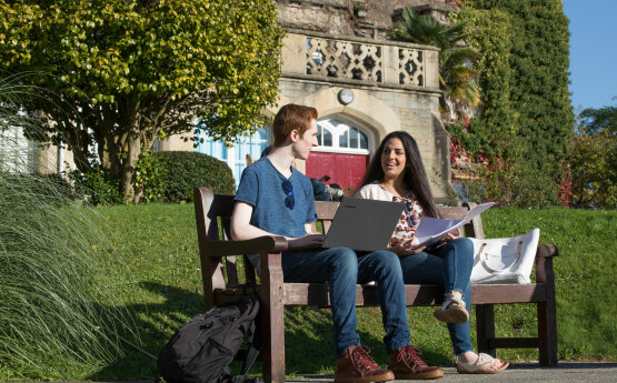 Students sitting on a bench chatting