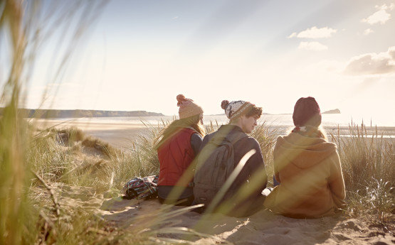 students sitting on the beach