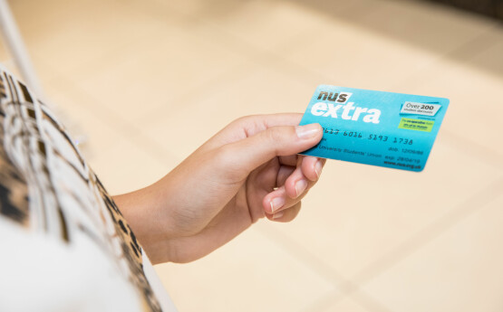Hand holding NUS card