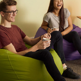 Smiling people sitting on beanbags