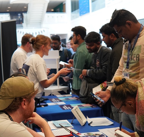 Students picking up leaflets at careers fair 