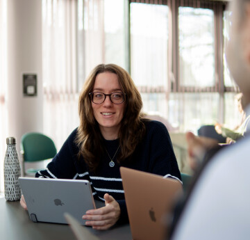 Woman sitting in front of laptop