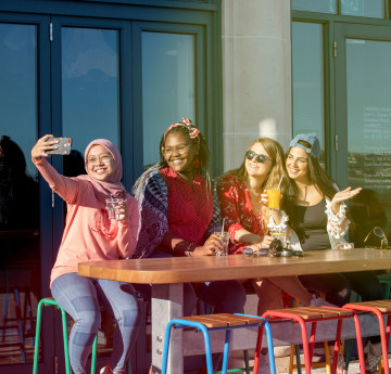 Students sitting outside the College building