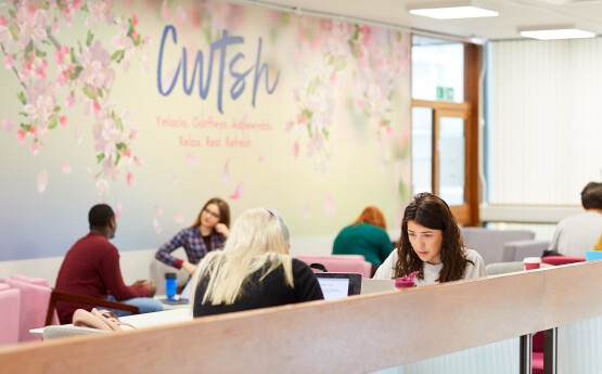 Students working at desks with word 