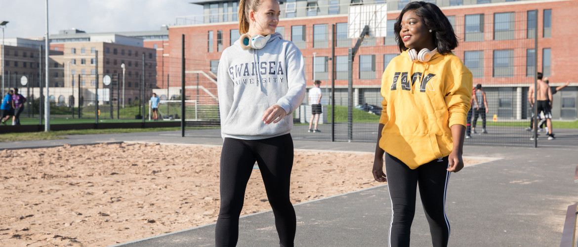 Two students walking on Bay Campus.