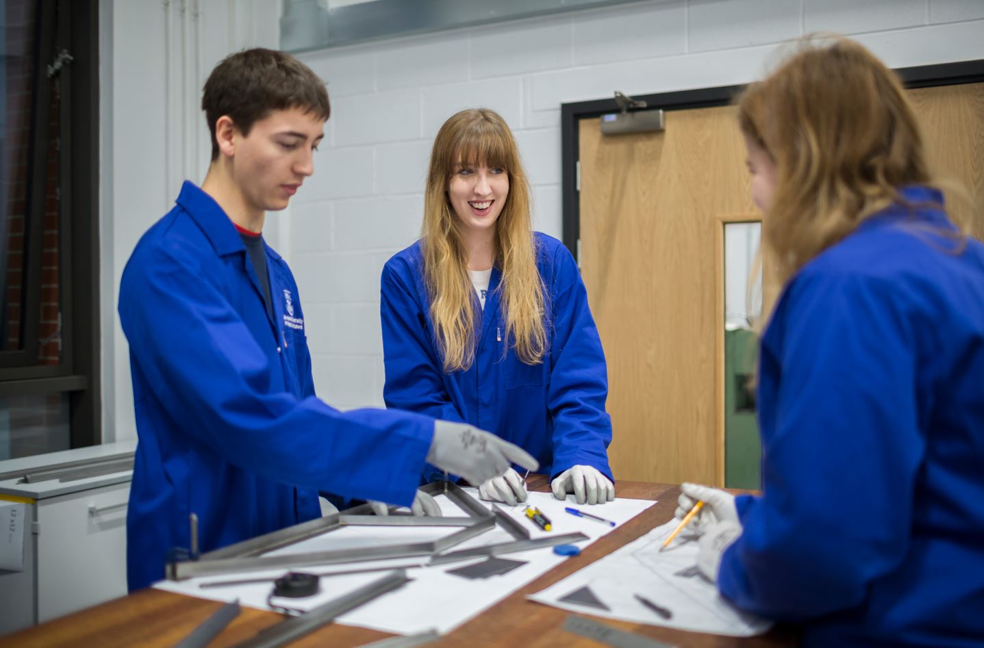 Students in engineering lab around table