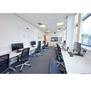 Room with 10 desks,monitors and chairs