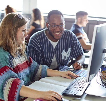 Two students working together at a computer