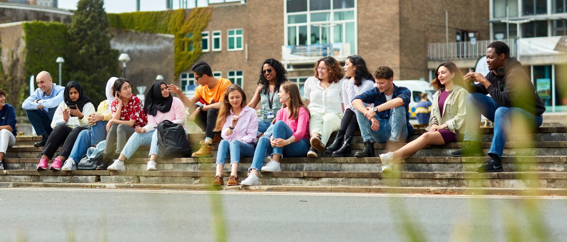 A group of students sitting on the steps of Fulton lawn, Singleton Campus