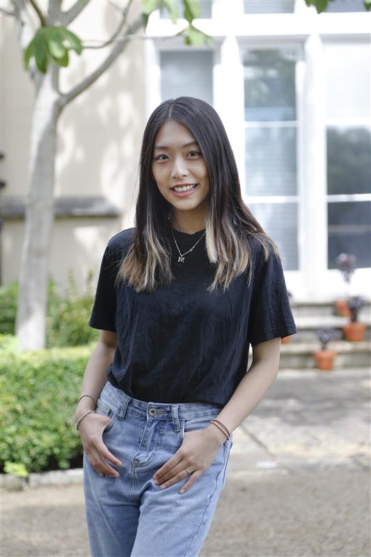 The Welfare Officer of Swansea University Students' Union, Melody Lin, stood outside of Singleton Abbey. 