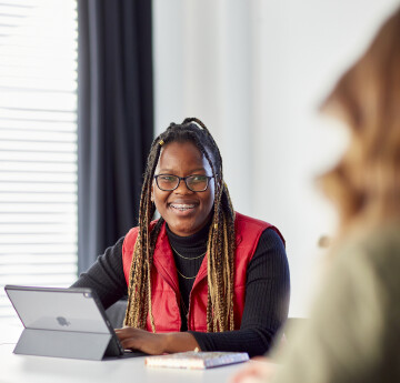 Students smiling at laptop