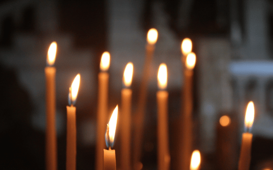 Thin gold candles burning